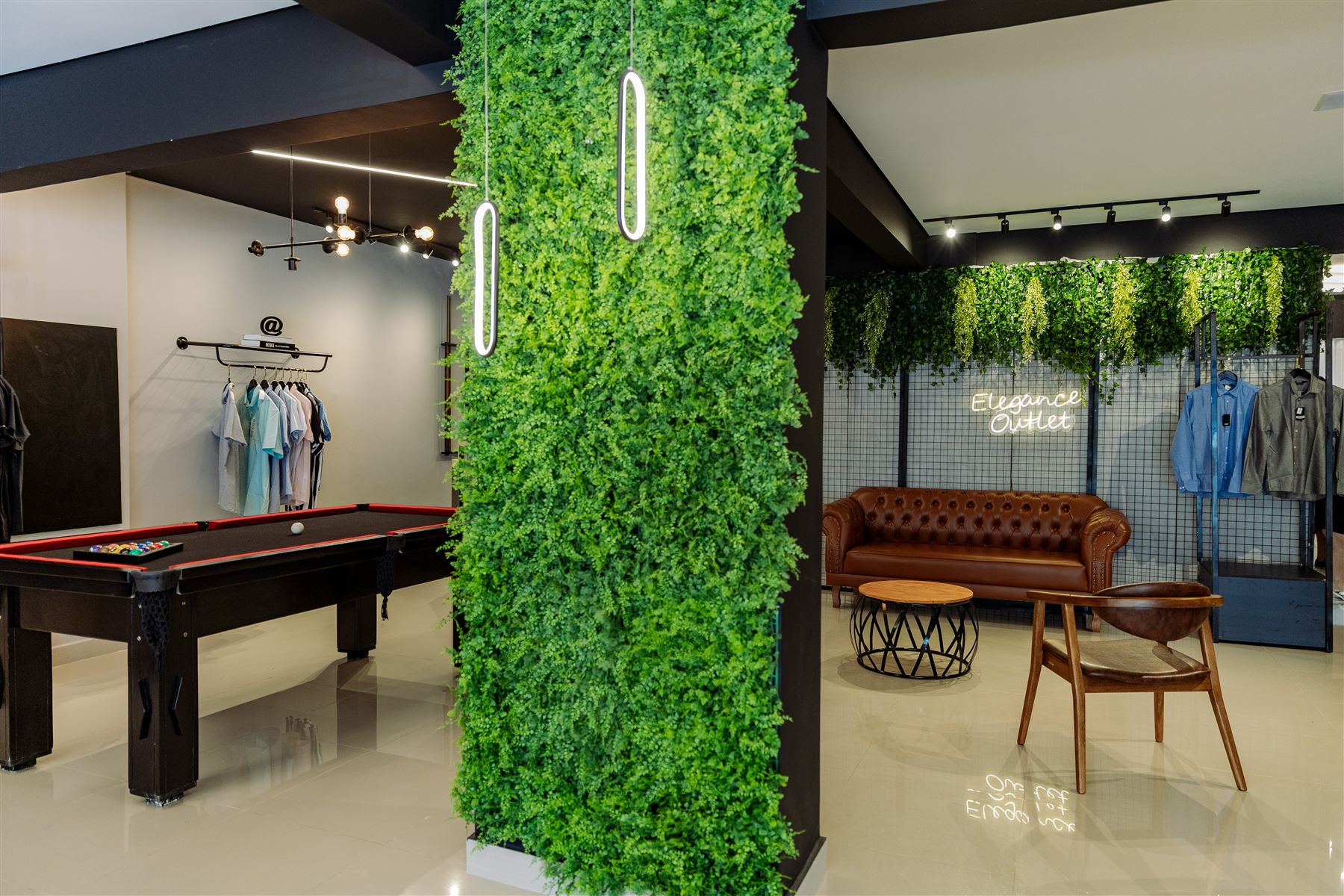 Sala de sinuca da loja Elegance Outlet, com parede de jardim vertical